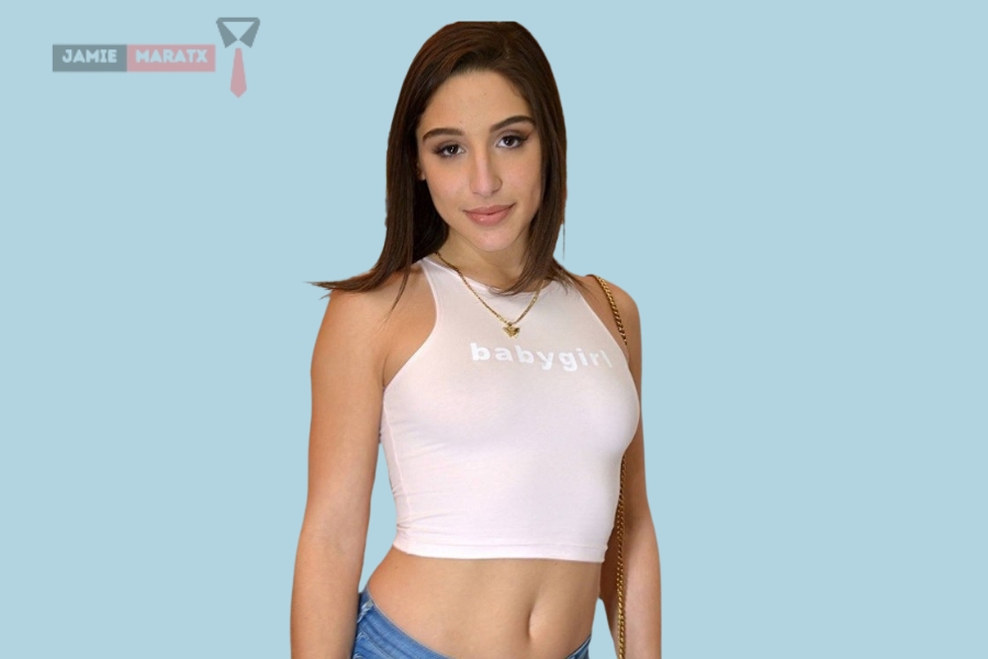 Abella Danger smiling in a white top with "babygirl" text, featured image for the blog post "Abella Danger Net Worth".