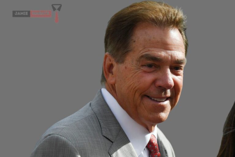 Nick Saban smiling in a formal suit, representing his success and legacy featured in the blog post "Nick Saban Net Worth."