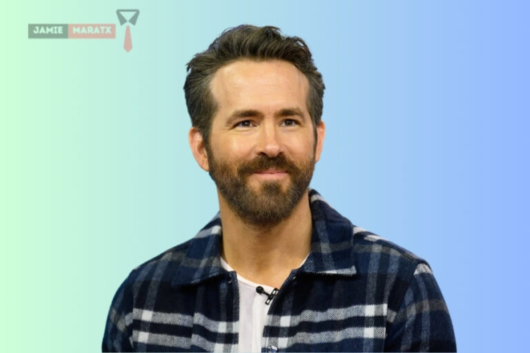 Ryan Reynolds smiling in a plaid shirt, featured in the blog post “Ryan Reynolds Net Worth”.