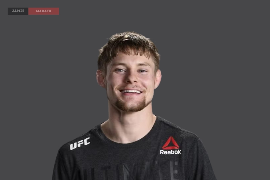 Bryce Mitchell smiling in a UFC Reebok shirt, representing his MMA career and financial success.