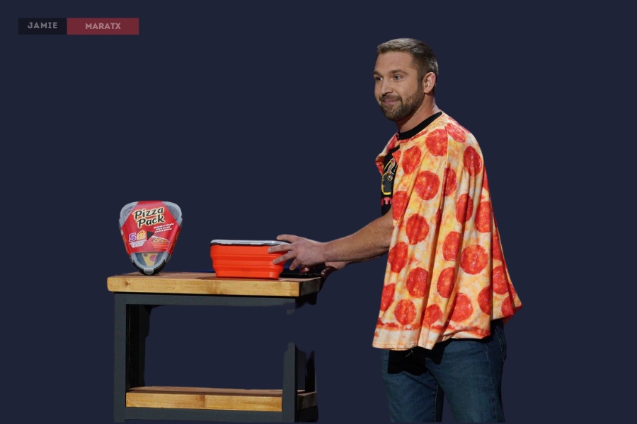 A man wearing a pizza-themed cape presents the Pizza Pack, a collapsible pizza storage container, on a stage.