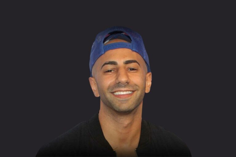 FouseyTube smiling while wearing a backwards blue cap