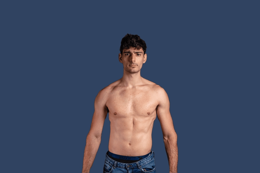 Ice Poseidon standing shirtless against a dark blue background.