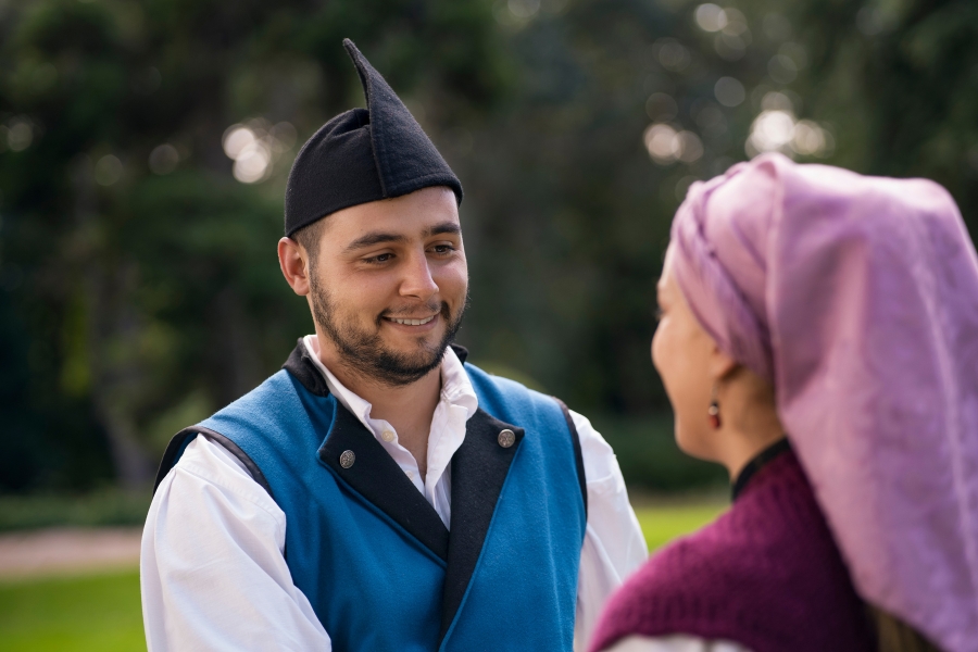 Malay couple in traditional attire smiling at each other outdoors — symbolic of local stories featured on Kepala Bergetar.