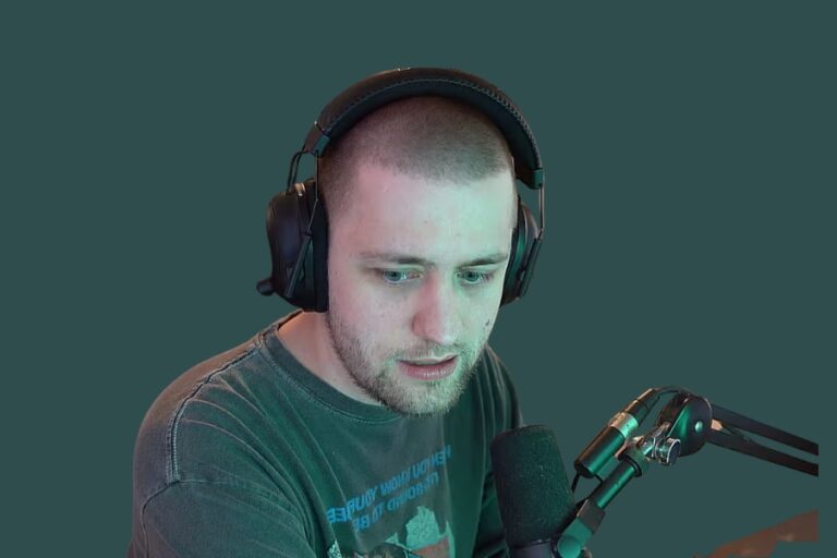 Sodapoppin wearing a headset and speaking into a microphone, representing the sodapoppin blackface controversy involving resurfaced Twitch content