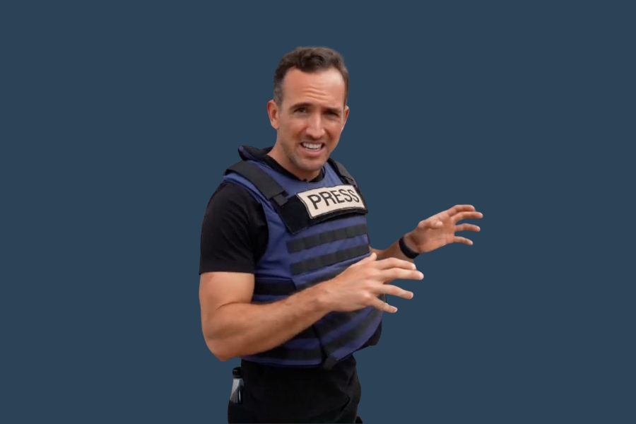 Journalist in press vest reporting from conflict zone