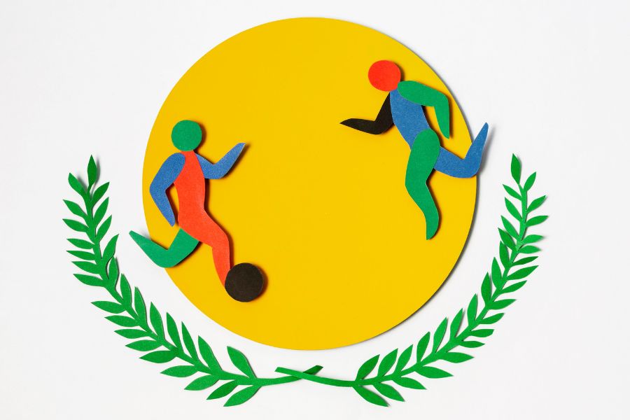 Colorful cut-out figures representing Olympic sports with a laurel wreath and yellow circle, symbolizing the cultural and human side of the Rio 2016 Olympics.